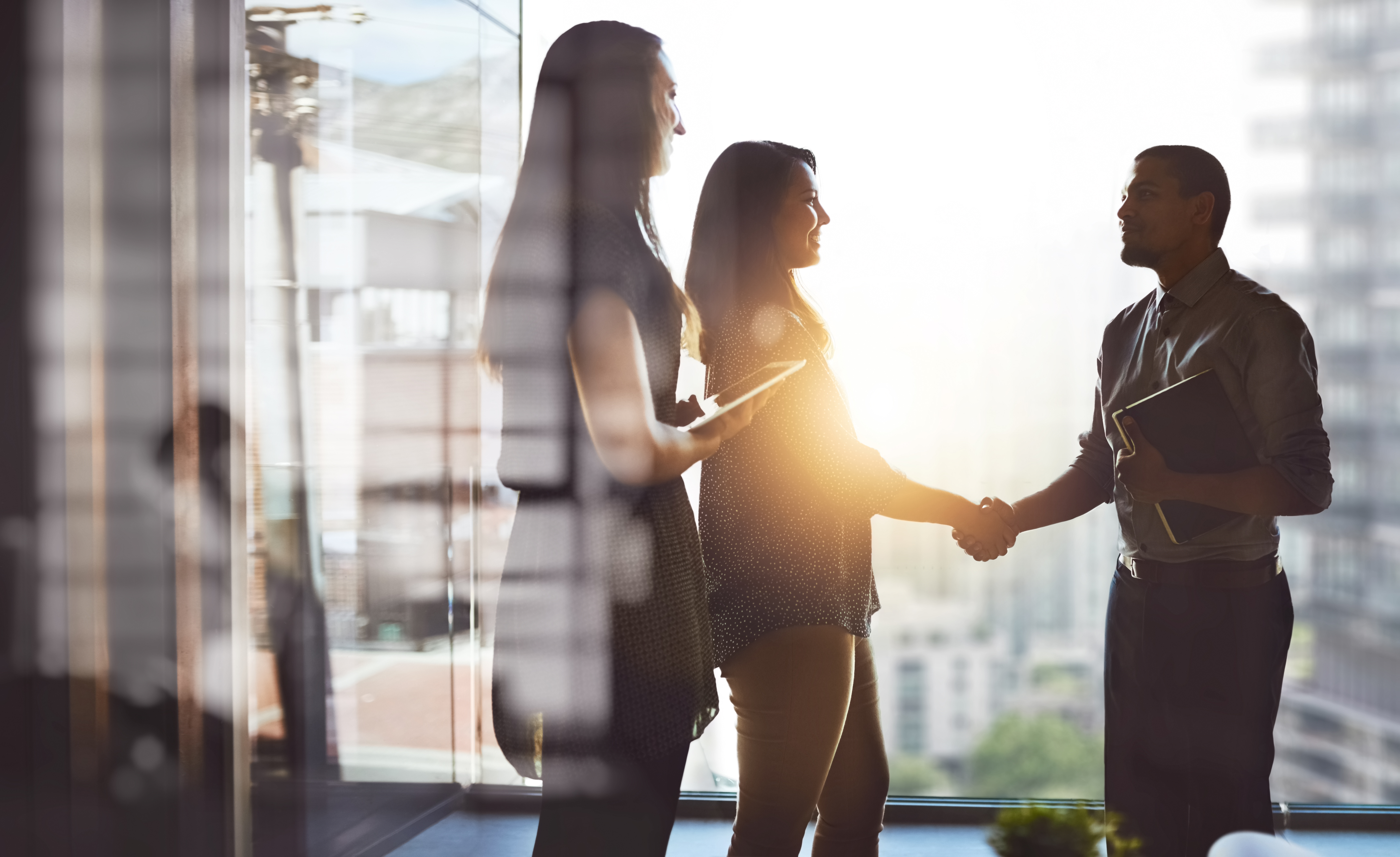 Women and men connecting in a bright modern workplace